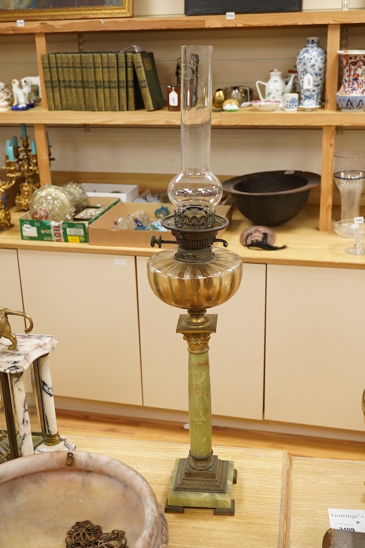 An onyx oil lamp with glass reservoir, 82cm high